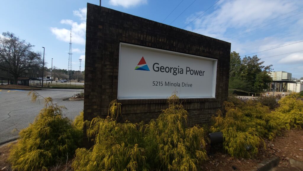 A Photo of a brick sign with the Georgia Power logo and name with the address 5215 Minola Drive